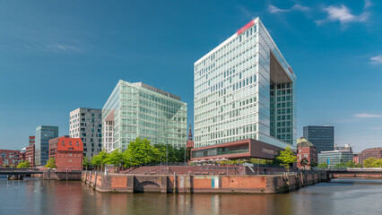 Obraz premium Timelapse of Hamburg HafenCity skyline at Ericusgraben with a view of modern Spiegel office buildings