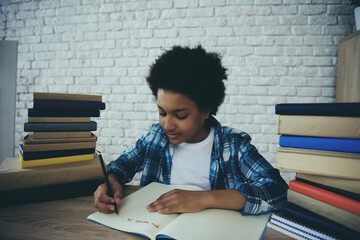 African American little boy does homework at home