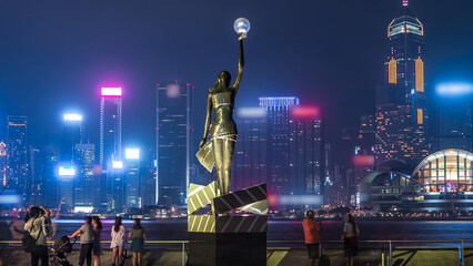 Bronze statue of Hong Kong Film Awards and skyline in Avenue of Stars timelapse hyperlapse.