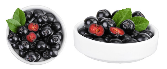Chokeberry with leaf in a ceramic bowl isolated on white background. Black aronia. Top view. Flat lay