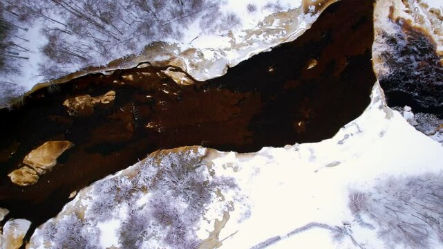 aerial view of winter river and waterfall