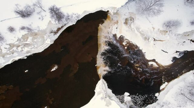 aerial view of winter river and waterfall