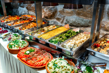Colorful buffet spread featuring fresh salads, roasted vegetables, and vibrant side dishes at a festive gathering