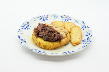 A plate of food with a piece of bread on the side