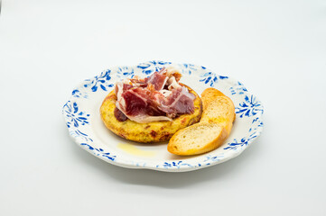 A plate of food with a piece of bread and a piece of meat