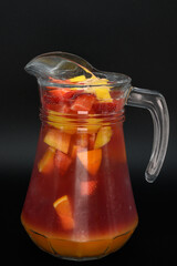 A pitcher of fruit punch is sitting on a table