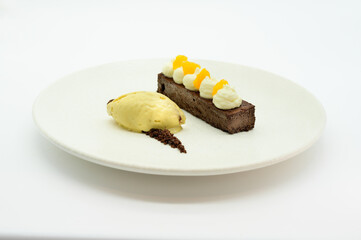 A dessert plate with a chocolate cake and a scoop of ice cream