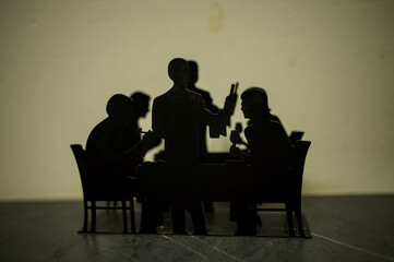 Sillhouette having a meal together