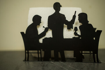 Sillhouette having a meal together.