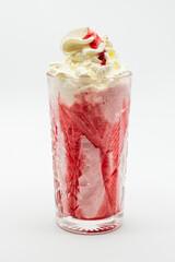 A glass of pink drink with whipped cream on top