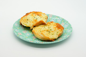 Two pieces of cheese toast on a blue plate