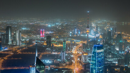 Skyline with Skyscrapers night timelapse in Kuwait City downtown illuminated at dusk. Kuwait City, Middle East