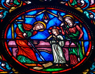 Stained glass (19th century) of Holy family: Jesus infant, Virgin Mary and St Joseph in the workshop of Joseph the carpenter.