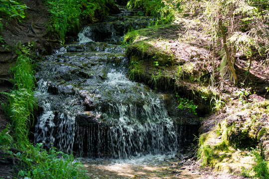 A picturesque stream flowing down the stone ledges in the forest