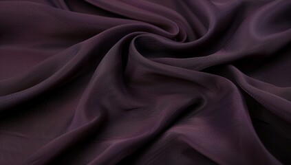 Fototapeta premium Elegant dark plum fabric with swirling folds and soft matte texture