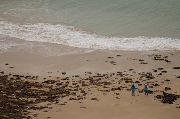 Two people in Lourtuais beach. Cape Erquy. Cotes-d'Armor department. Brittany. France.
