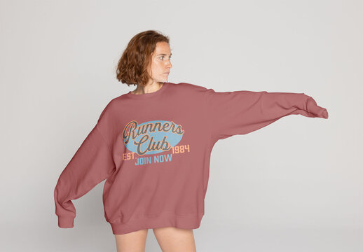 Mockup of Redhead Woman Models Oversized Jumper in Simple Studio Setting