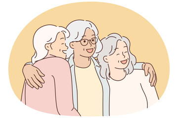 Three elderly women laugh and hug for first time having met after long separation