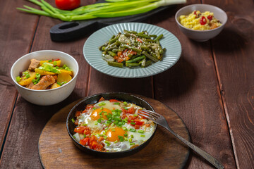 Set table, Jewish food, tzimmes, chelnt, shakshuka and couscous