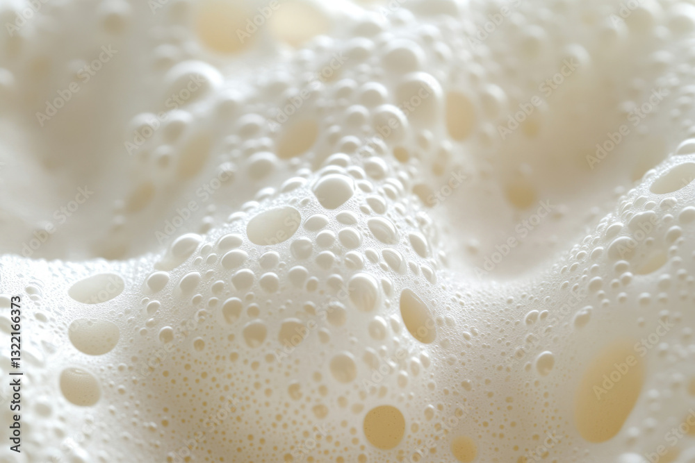 Poster close-up of creamy, textured foam with various sized bubbles.