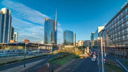 Naklejka premium Milan skyline with modern skyscrapers in Porta Nuova business district timelapse hyperlapse in Milan, Italy, at sunset.