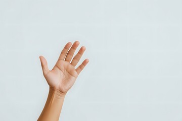 Raised open palm of Asian person showing empty hand against light background, minimal composition for business, education or social concepts.