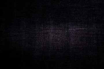 Background close-up of denim black canvas with subtle texture, perfect for backgrounds and art projects.