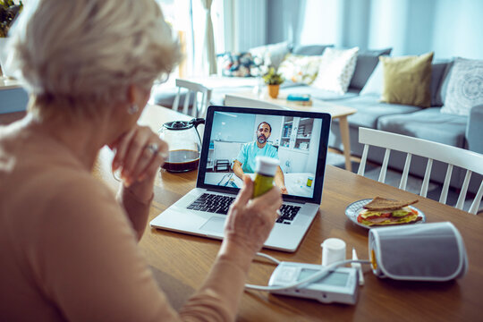 Senior woman having video call with doctor from home
