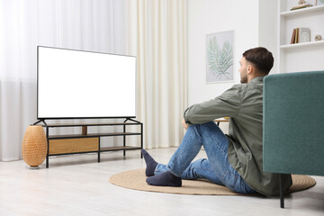 Man watching tv on floor at home