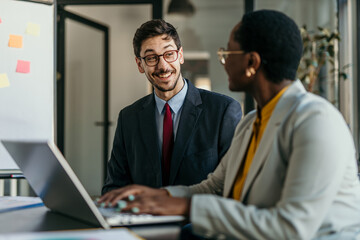 Professional team reviewing documents and discussing company growth
