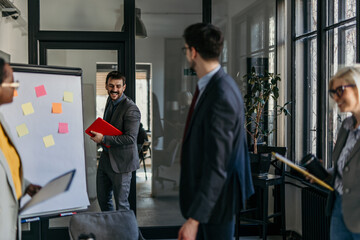 Group of businesspeople in formal attire discussing financial reports