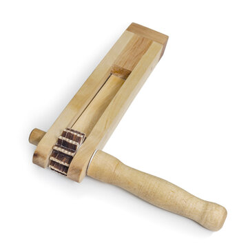 Russian ratchet, a traditional folk musical instrument on a white