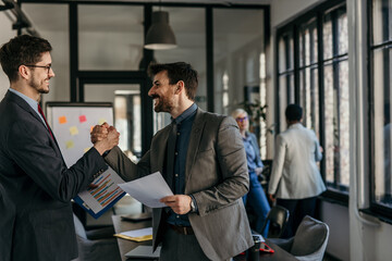 Business team analyzing reports while collaborating in an office space