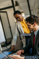 Diverse businessman and businesswoman engaged in a productive office meeting