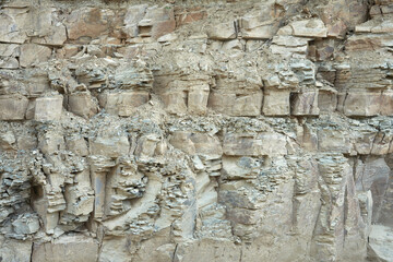 Natural outcrop of sedimentary rock. Cracked layers of limestone and mudstone. Background image. Copy space.