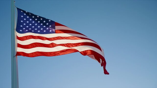 American flag gracefully waving in the wind, symbolizing national heritage and freedom. Captured in 120fps slow motion to emphasize movement, pride, and the enduring spirit of the United States.