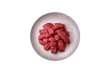 Raw beef tenderloin cut into slices with salt and spices