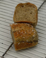 Freshly baked brown bread cooling on a wire rack in a cozy kitchen setting