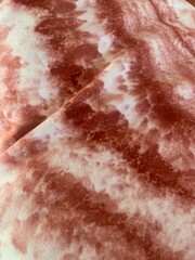 Tie dye red and white fabric textured background