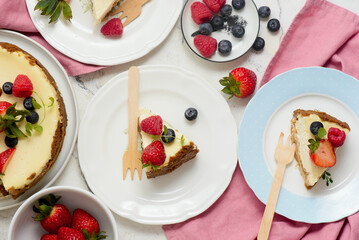 Pieces of cheesecake with berries on plates.top veiw..style hugge