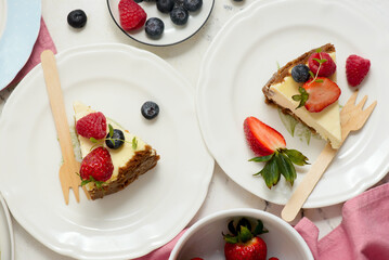 Pieces of cheesecake with berries on plates.top veiw..style hugge