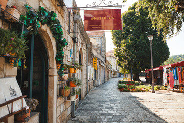 Croatia, Cavtat, 12.08.2019: The picturesque stone street of the Old Town is decorated with lush plants, colorful pots