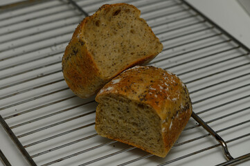 Freshly baked artisan bread cooling on a wire rack in a cozy kitchen during a sunny afternoon