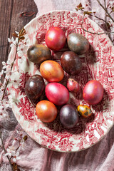 Eggs painted in different colors and covered with mother-of-pearl, and blossoming plum branches....