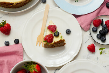 Pieces of cheesecake with berries on plates.top veiw..style hugge
