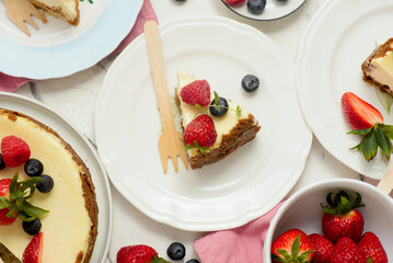 Pieces of cheesecake with berries on plates.top veiw..style hugge