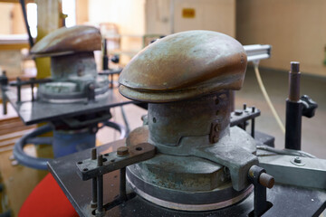 Crafting vintage felt hats with timeworn molds at a workshop in an artistic space