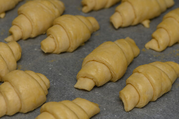 Delicious croissants being prepared in a cozy bakery during early morning hours for fresh pastries