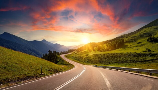 A winding asphalt highway stretching through lush green mountains under a dramatic sunset skay