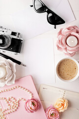 workspace with notebook keyboard, photo camera, open notebook, sketchbook and coffee on white background. Flat lay, top view office table desk.